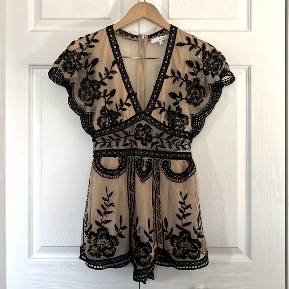 Nude and Black lace romper in size small.